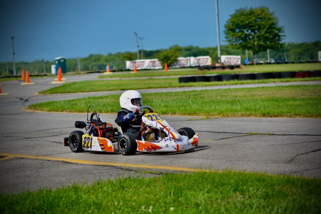 Hunter, age five, drives kart #221 through a corner.